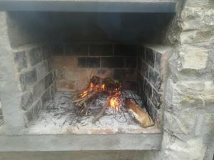 a brick oven with a fire in it at Detached rural 19th century country house in Calonge de Segarra