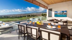 a dining room with a table and chairs and a pool at MAUNA KEA BEACH ESCAPE Luxurious home in private community with Heated Private Pool and Spa Detached Ohana Suite in Waimea