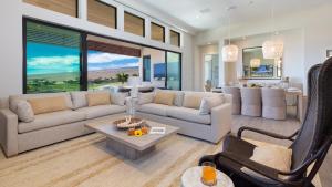 a living room with a couch and a table at MAUNA KEA BEACH ESCAPE Luxurious home in private community with Heated Private Pool and Spa Detached Ohana Suite in Waimea