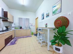 a kitchen with a table and a plant in it at Sri Ixora Kajang Fully Air Con Suite in Kajang