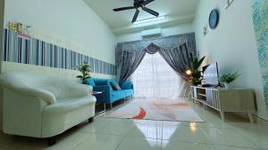 a living room with a couch and a tv at Sri Ixora Kajang Fully Air Con Suite in Kajang
