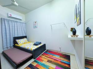 a living room with a couch and a colorful rug at Sri Ixora Kajang Fully Air Con Suite in Kajang