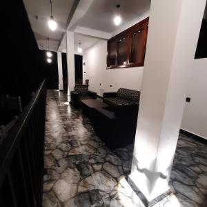 a lobby with couches and a stone floor at Ameliora Hotel Ella in Ella