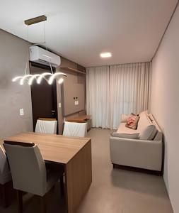 a room with a table and chairs and a bed at Apt sensacional Liv Residence pertinho da praia ! in Maceió