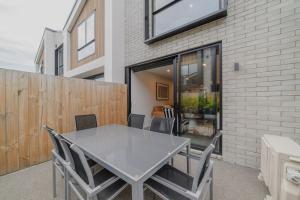 a white table and chairs on a patio at Modern Addington Escape Stylish 2br Townhouse in Addington