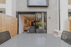 a view of a living room with a glass door at Modern Addington Escape Stylish 2br Townhouse in Addington +26 photos