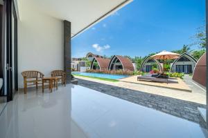 a view from the house of the swimming pool and the backyard at Twin Room with Kitchen & Pool in Uluwatu - No 4 in Bingin Beach