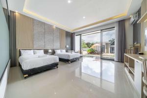 a bedroom with two beds and a large window at Twin Room with Kitchen & Pool in Uluwatu - No 4 in Bingin Beach +17 photos