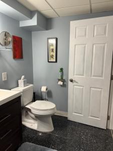 a bathroom with a toilet and a white door at Nice and Cozy! in Lincoln +18 photos