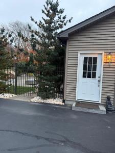 a house with a white door and a fence at Nice and Cozy! in Lincoln