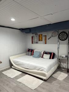 a bedroom with a large white bed with pillows on it at Nice and Cozy! in Lincoln