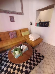 a living room with a couch and a table at Casa Posada Rústica - A 1 minuto del Jardín Unión in Guanajuato +23 photos
