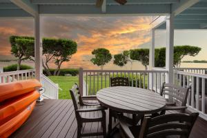 a porch with a table and chairs and a view of the water at 5035 "Villa del Sol"- Amazing Sunset Views! 2bed 3bath in Duck Key