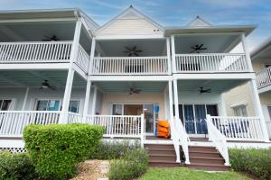 a large white house with a front porch at 5035 "Villa del Sol"- Amazing Sunset Views! 2bed 3bath in Duck Key +50 photos