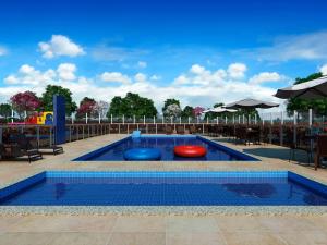 a swimming pool with threelatable objects in it at Apartamento com piscina e garagem privativa in Londrina