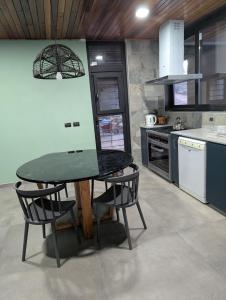 a kitchen with a table with a laptop on it at Relax en San Nicolás in Villa San Nicolás