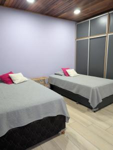 a room with two beds and a wall at Relax en San Nicolás in Villa San Nicolás