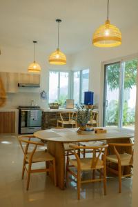 a kitchen with a large wooden table and chairs at Casa Atara in Flores