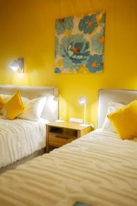 two beds sitting next to each other in a room at Casa Atara in Flores +36 photos