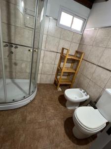 a bathroom with a toilet and a shower and a sink at Cabañas Refugio Lavanda in Villa de Las Rosas