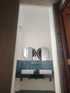 a bathroom with two sinks and two mirrors at The windsor Retreat in Moratuwa +11 photos