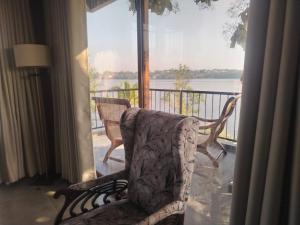 a room with a chair in front of a window at The windsor Retreat in Moratuwa