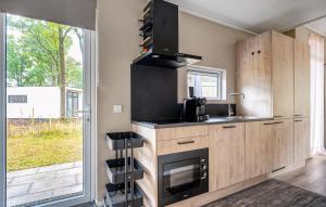 a kitchen with a stove top oven next to a window at 2 Bedroom Stunning Home In Hellendoorn in Hellendoorn