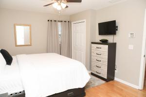 een slaapkamer met een bed en een flatscreen-tv bij Family Fun Vibe in Marietta