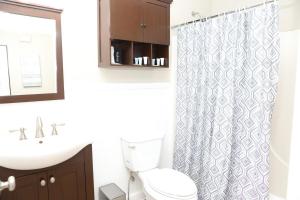 een badkamer met toilet en douchegordijn bij Family Fun Vibe in Marietta +16 foto's