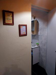 a small bathroom with a sink and a microwave at La casa de las flores in Las Heras