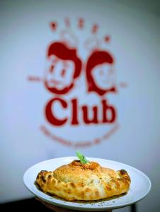 a white plate with a piece of food on it at Lienzo Hostel and Mural Art Museum in Popayan +27 photos