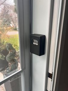 a window with a clock on the side of a door at Gull lake in Winnipeg +6 photos