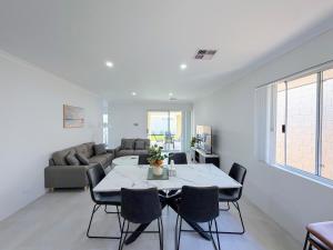 a living room with a table and a couch at Brabham Modern Stay Close to Swan Valley in West Swan