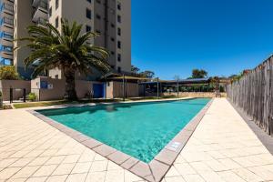 a swimming pool in front of a building at WELL82 - Ocean Heights in Mosman Park