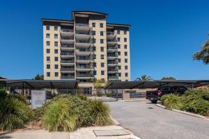 a parking lot in front of a large building at WELL82 - Ocean Heights in Mosman Park