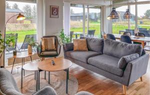 a living room with a couch and chairs and tables at Cozy Home In Hjørring With Wifi in Hjørring