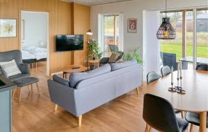 a living room with a couch and a table at Cozy Home In Hjørring With Wifi in Hjørring