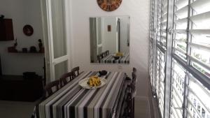 a dining room with a table and a mirror at Marina's Home By The Sea in Bat Yam