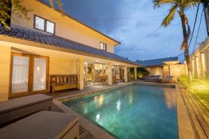 a swimming pool in the backyard of a house at Villa Amana Seminyak in Seminyak