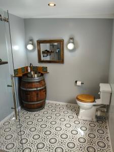 a bathroom with a barrel sink and a toilet at Maungatapu Hut in Rai Falls