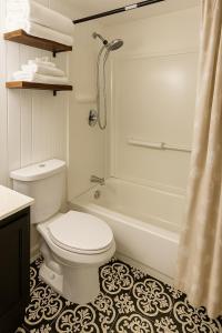 a bathroom with a toilet and a tub and a shower at Bright & Stylish Guest Suite with Modern Comforts in Selden