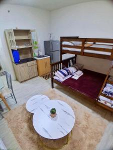a living room with a bunk bed and a table at Amaia Steps Altaraza by GEMcondotel JAMYATZ HOMESTAY in Tunkong Manga
