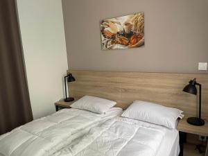 a bedroom with two beds and a painting on the wall at Gourette : Appartement 3 pièces, 8 pers, animaux admis - FR-1-860-6 in Gourette
