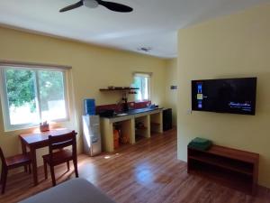 a living room with a table and a flat screen tv at Dom's Oase in Panglao Island