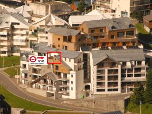 a building with a sign on it in a city at Appartement 8 pers, 2 pièces, piscine, animaux admis, Gourette - FR-1-860-23 in Gourette