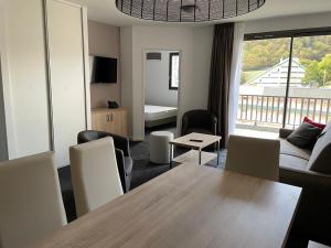 a living room with a table and a couch at Gourette: Appartement 6 pers, 2 pièces, Animaux admis - FR-1-860-30 in Gourette