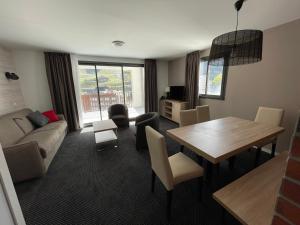 a living room with a table and a couch at Appartement 2 pièces, 6 pers, piscine, animaux acceptés - FR-1-860-40 in Gourette