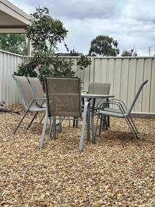 a group of chairs and a table in a backyard at Sunny Shackell - Echuca Moama Holiday Accommodation in Echuca