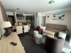 a living room with a couch and a table at Appartement spacieux pour 8 personnes à Gourette avec piscine et animaux acceptés - FR-1-860-18 in Gourette +4 photos