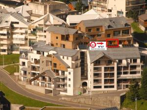 a building with a no parking sign on top of it at Studio cabine 7 pers, piscine, animaux admis, Gourette - FR-1-860-22 in Gourette